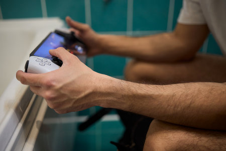Someone Using a Device While Relaxing in a Comfortable Bathroom Setting