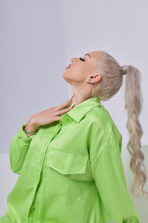 A Trendy Portrait Featuring a Stylish Young Woman Dressed in a Bright Neon Outfitの写真素材