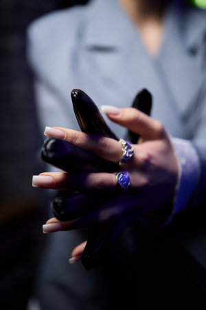 Exquisite and Elegant Hands Dressed in Fashionable and Stylish Black Gloves for All Occasionsの写真素材