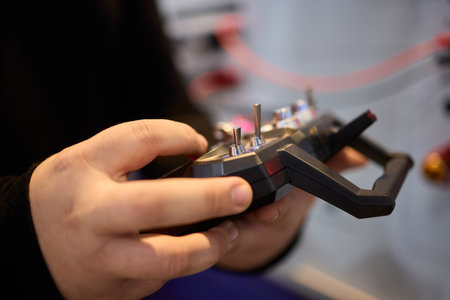 A Person Skillfully Operating a Remote Control Device in a Contemporary Modern Setting