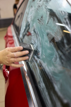 Car Detailing Meticulously Cleaning Your Windshield with Care for an Immaculate Appearanceの写真素材