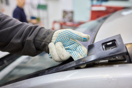 Automobile special workers remove old windscreen or windshield of a car in auto service station garage. Backgroundの写真素材