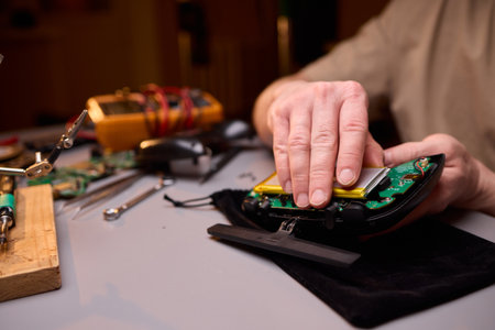 User Engaging in the Repair and Restoration of a Device Comprehensive Electronics Workの写真素材