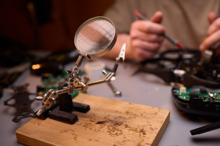 Conducting Detailed and Precise Repair Work Using Various Tools and Electronic Componentsの写真素材