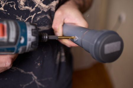 Hands skillfully using essential tools for a plumbing installation project effectively