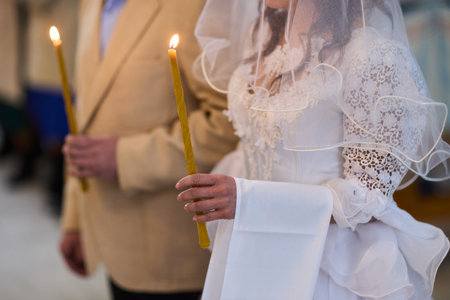 An Elegant Bride Holding a Candle During a Beautiful Wedding Ceremony Celebration Eventの写真素材