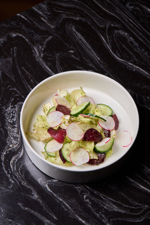 A vibrant and healthy Fresh Garden Salad made with crisp Radishes and cooling Cucumbersの写真素材