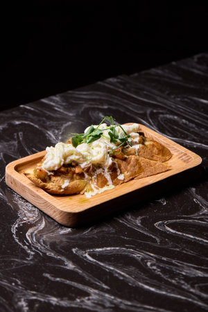 A Mouthwateringly Delicious Gourmet Dish Impeccably Served on a Rustic Wooden Plateの写真素材