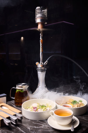 Indulge in an exquisite hookah experience accompanied by a selection of gourmet dishes to savorの写真素材