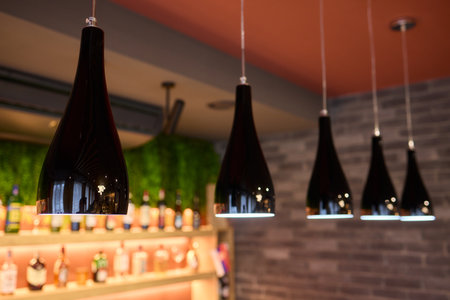 Stylish and Chic Black Pendant Lights in a Contemporary Modern Bar Setting and Ambianceの写真素材