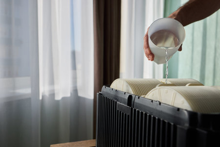 Pouring liquid into a storage container daily improves organization and efficiencyの写真素材