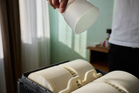 Pouring liquid into a storage container daily improves organization and efficiencyの写真素材