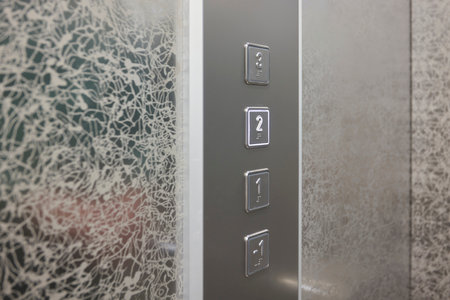 The modern elevator control panel features a display showcasing the current floor number
