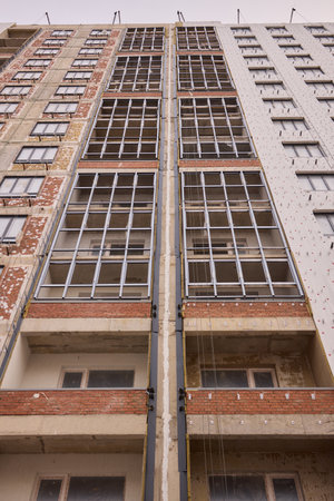 Urban Construction A Modern Building is Under Development in the Cityscape Area Nearbyの写真素材