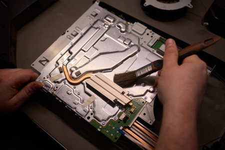 Skilled Hands Engaged in Repairing Electronic Devices Using a Variety of Specialized Tools
