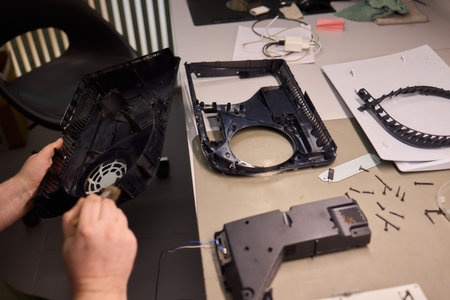 Skilled Hands Engaged in Repairing Electronic Devices Using a Variety of Specialized Tools