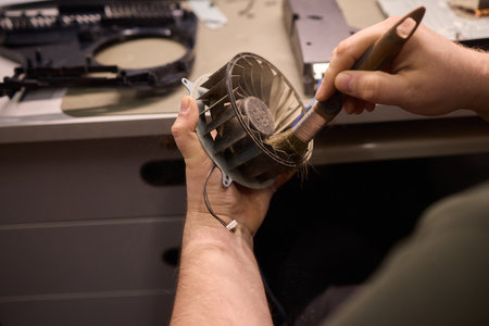 A Close Up and Detailed Examination of a Turbine Fan Component Held in Hand for Review
