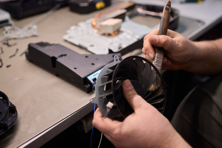 A Close Up and Detailed Examination of a Turbine Fan Component Held in Hand for Review