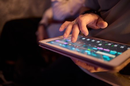 Engaging in Digital Interaction with a Tablet in a Low Light Setting A Modern Experienceの写真素材