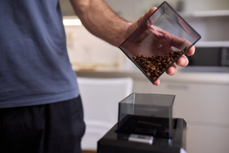 Pouring Coffee Beans into a Container for your brewing process each morning is essentialの写真素材