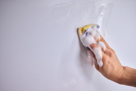 Cleaning the Kitchen Wall effectively with a Sponge and some good detergent for hygiene