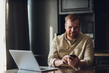 Mid age man working on laptop at home.の写真素材