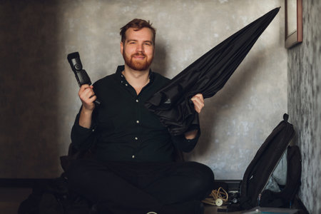 Photographer holding white umbrella for strobe in studio.の写真素材