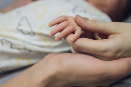 Baby Hand, Father Hold New Born Kid, Parent Touch Newborn Child, Family Help Care Concept.