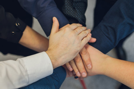 Closeup of peoples hands working together team.