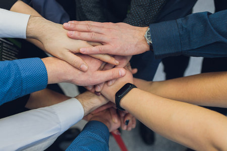 Closeup of peoples hands working together team.