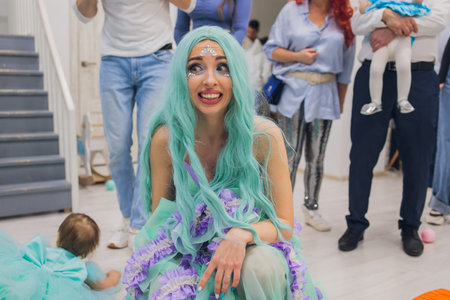 A Whimsical Mermaid Character Engaging at a Colorful and Festive Community Eventの写真素材