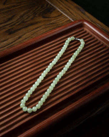 Colorful beads made of natural semiprecious stones on a white background. Isolated jewelry close up. Stone texture, beaded necklaces, rock.の写真素材