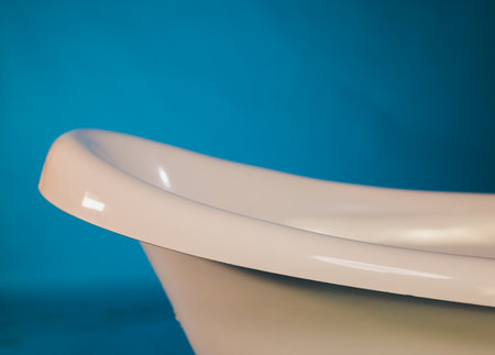 Sophisticated and Elegant White Bathtub Positioned Beautifully Against Aqua Background Settingの写真素材