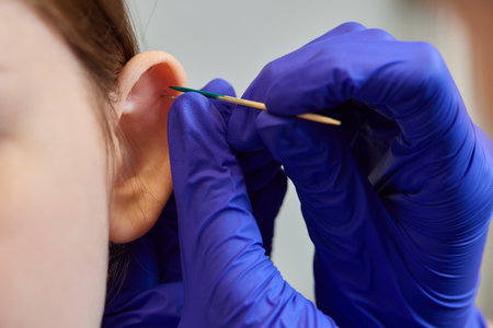 piercings on an ear. Conch and helix piercings close up.の写真素材