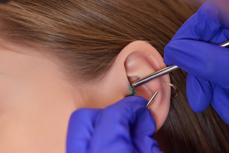 piercings on an ear. Conch and helix piercings close up.