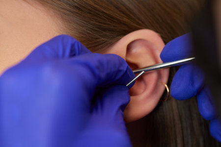 piercings on an ear. Conch and helix piercings close up.の写真素材