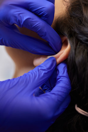 piercings on an ear. Conch and helix piercings close up.の写真素材