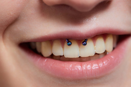 Girl lower lip piercing. Labret piercing. Macro. Blue ball.の写真素材