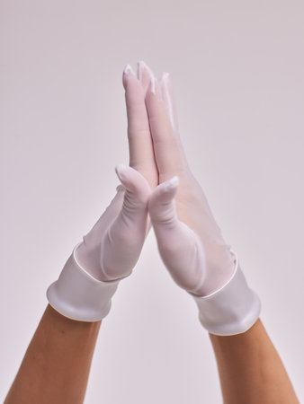 Female hands in transparent black gloves on dress background. Retro style.の写真素材