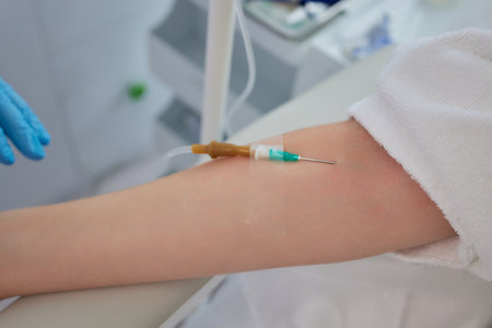 A swab is pressed onto the injection site during the blood collection.の写真素材