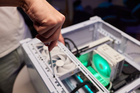 Computer technician installs cooling system of computer.の写真素材
