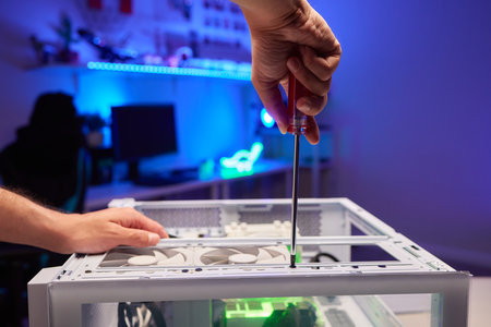 Computer technician installs cooling system of computer.の写真素材