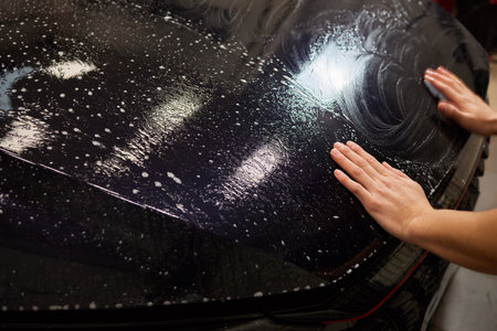 Protection of hood and front of the car with a colorless protective film.の写真素材