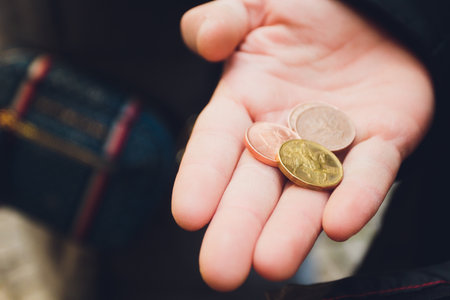 A hand of coins in the palm.の写真素材