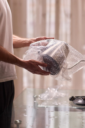 Unboxing a stylish, modern kettle designed for use in a bright, contemporary kitchen spaceの写真素材