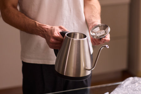 Unboxing a stylish, modern kettle designed for use in a bright, contemporary kitchen spaceの写真素材