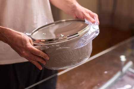 Meticulously Preparing Ingredients with Careful Wrapping for an Exquisite Cooking Experienceの写真素材