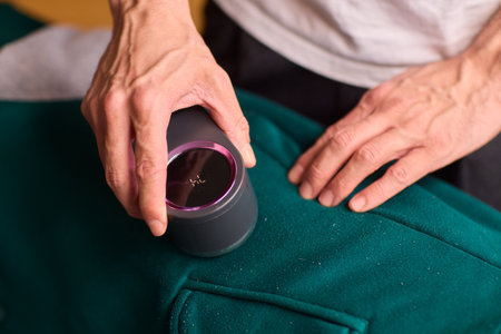 Effectively Removing Lint from a Beautiful Sweater Using a Handy and Useful Lint Roller Toolの写真素材