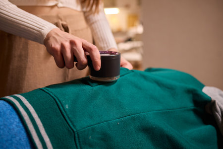Effectively Removing Lint from a Beautiful Sweater Using a Handy and Useful Lint Roller Tool