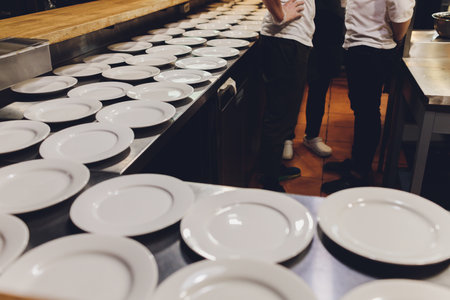 Many white ceramic porcelain utensils plates on the table. Pottery background.の写真素材